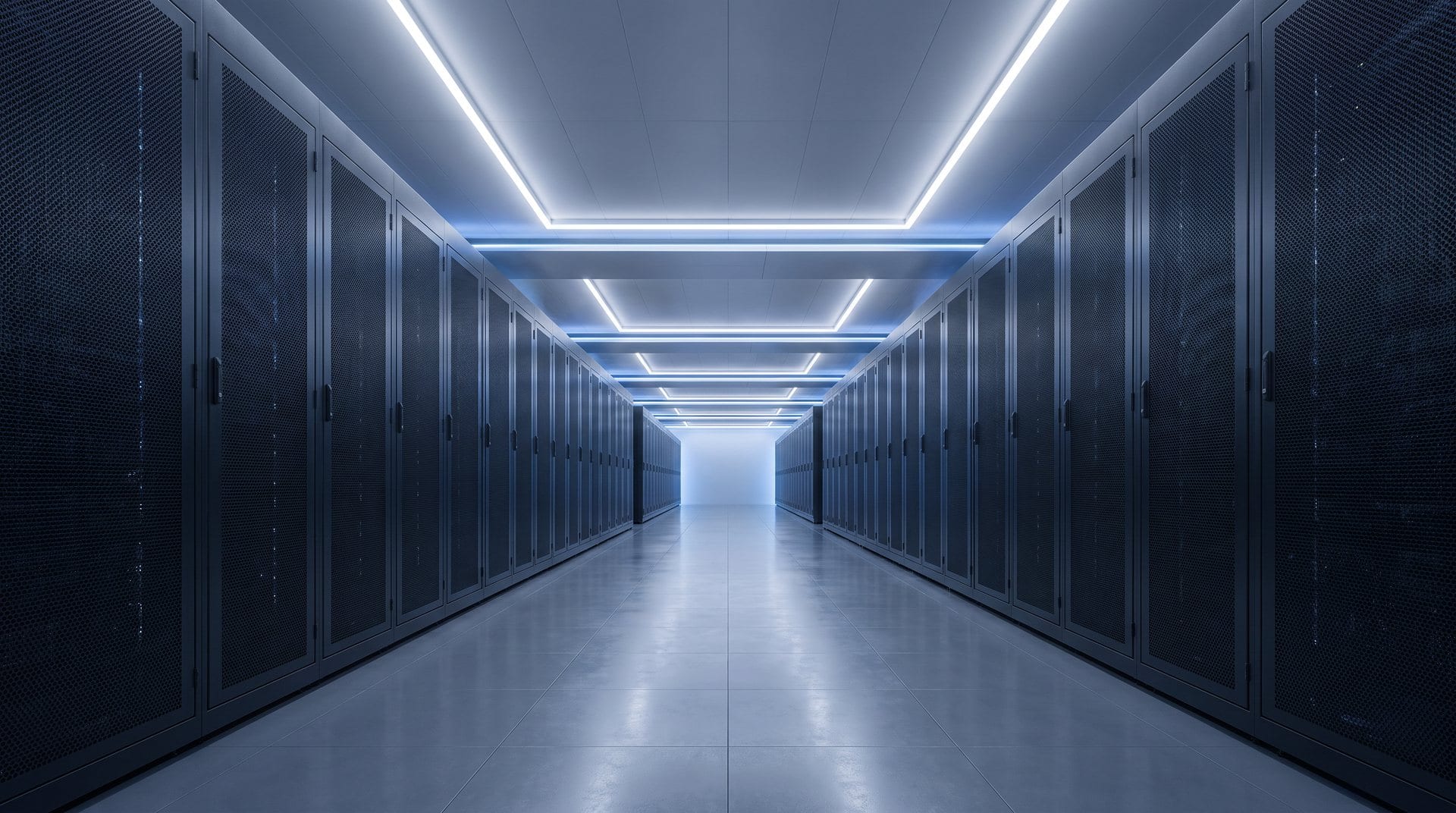 Aisle between two rows of closed, mesh-fronted server cabinets under recessed ceiling lighting