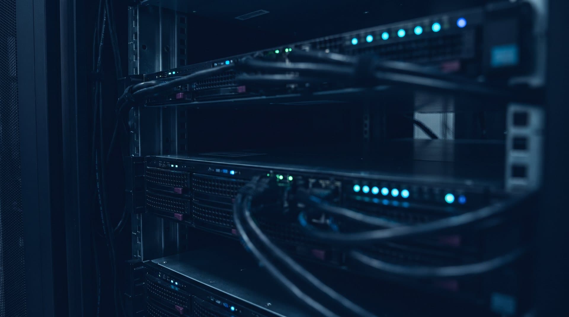 Status lights glowing inside a dark server rack