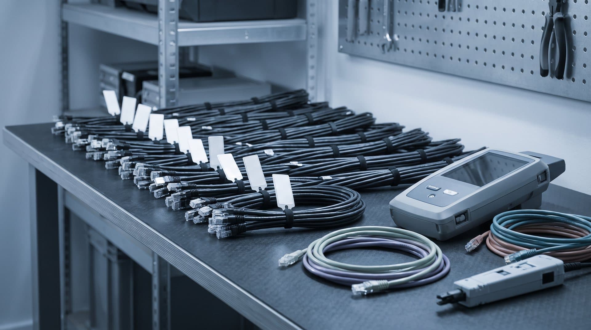 Network engineering bench with labelled cable looms and test equipment